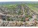 Aerial view showing the home situated within a neighborhood near a golf course and lake at 128 Baylor Dr, Longmont, CO 80503
