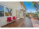 Backyard featuring a wood deck, hot tub, and lush landscaping at 128 Baylor Dr, Longmont, CO 80503