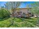 Spacious backyard featuring a wooden deck with a hot tub, ideal for relaxing and outdoor enjoyment at 128 Baylor Dr, Longmont, CO 80503
