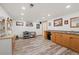 Finished basement area featuring a kitchenette, wood plank flooring, and natural light at 128 Baylor Dr, Longmont, CO 80503