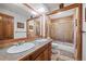 Well-lit bathroom with a large vanity with double sinks and tiled shower and tub at 128 Baylor Dr, Longmont, CO 80503