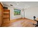 Bright bedroom with wood floors, modern track lighting, and a large window with views at 128 Baylor Dr, Longmont, CO 80503