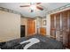 Bedroom featuring wood trim, ceiling fan, and neutral color scheme at 128 Baylor Dr, Longmont, CO 80503