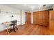 Bedroom with wood floors, closet, and a desk area perfect for a home office at 128 Baylor Dr, Longmont, CO 80503