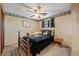 Bedroom with decorative wallpaper, ceiling fan, and a comfortable bed at 128 Baylor Dr, Longmont, CO 80503