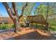 Outdoor deck features wooden railing and a mature tree growing through it, adding natural charm to the space at 128 Baylor Dr, Longmont, CO 80503