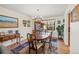 Cozy dining area with a classic wood table, chandelier lighting, and a large window at 128 Baylor Dr, Longmont, CO 80503
