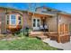 Inviting porch with seating, a bay window, and colorful landscaping, adding curb appeal to the home at 128 Baylor Dr, Longmont, CO 80503