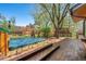 A hot tub is featured on a wooden deck, perfect for outdoor relaxation and entertaining on a sunny day at 128 Baylor Dr, Longmont, CO 80503
