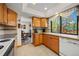 Bright kitchen with light wood cabinets and a large window providing a scenic view at 128 Baylor Dr, Longmont, CO 80503