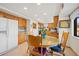 Open kitchen and dining area with classic wood cabinetry and bright, natural light at 128 Baylor Dr, Longmont, CO 80503