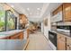 Traditional kitchen features wood cabinets, neutral countertops, and a large window with a view at 128 Baylor Dr, Longmont, CO 80503