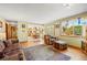 Inviting living room featuring wood floors and a view into the kitchen and backyard at 128 Baylor Dr, Longmont, CO 80503