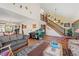 Open living space with high ceilings, hardwood floors, and a staircase to the upper level at 128 Baylor Dr, Longmont, CO 80503