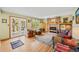 Spacious living room with fireplace, hardwood floors, and large glass doors to the outside at 128 Baylor Dr, Longmont, CO 80503