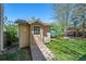 Charming backyard shed with a ramp, offering convenient storage and an appealing addition to the yard at 128 Baylor Dr, Longmont, CO 80503