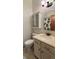Well-maintained bathroom featuring a classic vanity, toilet, and cabinet with fluted glass at 9610 W Chatfield Ave # F, Littleton, CO 80128