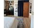 Bedroom featuring a filled closet with storage and an adjacent room with a blue floral rug at 9610 W Chatfield Ave # F, Littleton, CO 80128