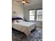Comfortable bedroom with large windows and a ceiling fan, providing plenty of natural light at 9610 W Chatfield Ave # F, Littleton, CO 80128