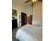 Bedroom with a ceiling fan, dresser, and closet, along with an adjacent room that can be accessed from the bedroom at 9610 W Chatfield Ave # F, Littleton, CO 80128