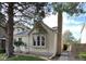 Charming home featuring a brick chimney, mature trees, and a well-maintained front yard at 9610 W Chatfield Ave # F, Littleton, CO 80128