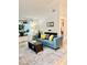 Bright living room with vaulted ceilings, hardwood floors, and a comfortable blue sofa at 9610 W Chatfield Ave # F, Littleton, CO 80128