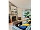 Cozy living room with a stone fireplace, plush sofa, and a large window at 9610 W Chatfield Ave # F, Littleton, CO 80128