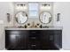 Double vanity bathroom with granite countertops and modern lighting at 12387 W 51St Ave, Wheat Ridge, CO 80033