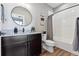 Modern bathroom with dark vanity and a shower/tub combo at 12387 W 51St Ave, Wheat Ridge, CO 80033