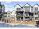 Modern two-story townhome with gray and white exterior at 12387 W 51St Ave, Wheat Ridge, CO 80033