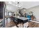 Open concept kitchen with island, looking toward stairs and living room at 12387 W 51St Ave, Wheat Ridge, CO 80033