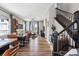 Bright and spacious living area with hardwood floors and a view of the staircase at 12387 W 51St Ave, Wheat Ridge, CO 80033