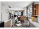 Open living room with hardwood floors, modern furniture, and a view to the kitchen at 12387 W 51St Ave, Wheat Ridge, CO 80033