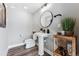 Stylish powder room with white pedestal sink and wood flooring at 12387 W 51St Ave, Wheat Ridge, CO 80033