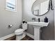 Modern powder room with pedestal sink, updated fixtures, and stylish decor at 12387 W 51St Ave, Wheat Ridge, CO 80033