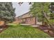 Landscaped backyard featuring a lawn, patio, and privacy fence at 176 S Rosemary St, Denver, CO 80230