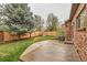 Backyard with green grass, a patio, and mature trees at 176 S Rosemary St, Denver, CO 80230