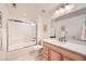 Bright bathroom with tile flooring, large mirror, and shower-tub combo at 176 S Rosemary St, Denver, CO 80230