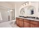 Bright bathroom with double sinks, ample counter space, and a shower/tub at 176 S Rosemary St, Denver, CO 80230