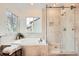 Luxurious bathroom with a soaking tub, a glass shower, and travertine tile at 176 S Rosemary St, Denver, CO 80230