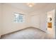 Carpeted bedroom with a large window and closet; ensuite bathroom at 176 S Rosemary St, Denver, CO 80230
