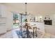 Bright dining area with sliding glass doors leading to the backyard, next to the living area at 176 S Rosemary St, Denver, CO 80230