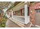 Charming front porch featuring white railings, brick accents, and cozy seating, ideal for relaxing outdoors at 176 S Rosemary St, Denver, CO 80230