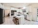 Bright kitchen with white cabinets, stainless steel appliances, and a center island with bar seating at 176 S Rosemary St, Denver, CO 80230