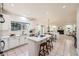 Bright kitchen with white cabinets, stainless steel appliances, and a center island adjacent to the dining area at 176 S Rosemary St, Denver, CO 80230