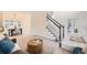 Comfortable living room featuring stylish furniture and decor, adjacent to the staircase and dining area at 176 S Rosemary St, Denver, CO 80230