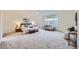 Spacious main bedroom with plush carpet, natural light, and seating area at 176 S Rosemary St, Denver, CO 80230