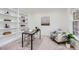 Cozy home office with built-in bookshelves, comfortable seating, and natural light, ideal for focused work or study at 176 S Rosemary St, Denver, CO 80230