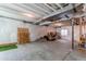 Unfinished basement with painted floor and walls, exposed ceiling, and window at 39167 Braxton Ln, Elizabeth, CO 80107