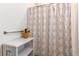 Bathroom features shower with patterned curtain, towel rack, and rustic white shelves at 39167 Braxton Ln, Elizabeth, CO 80107